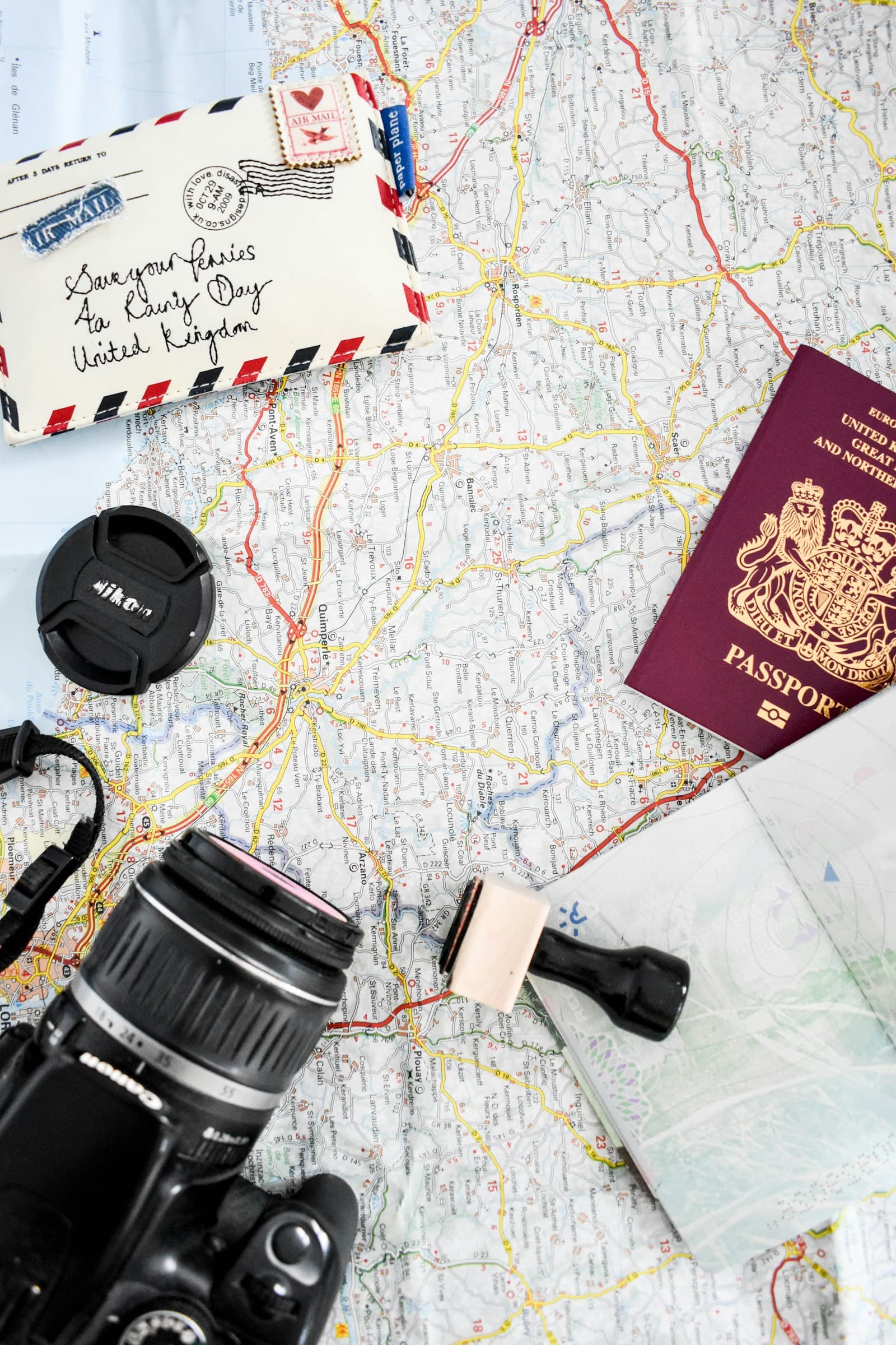 Travel map, passport and camera laid out for choosing a destination