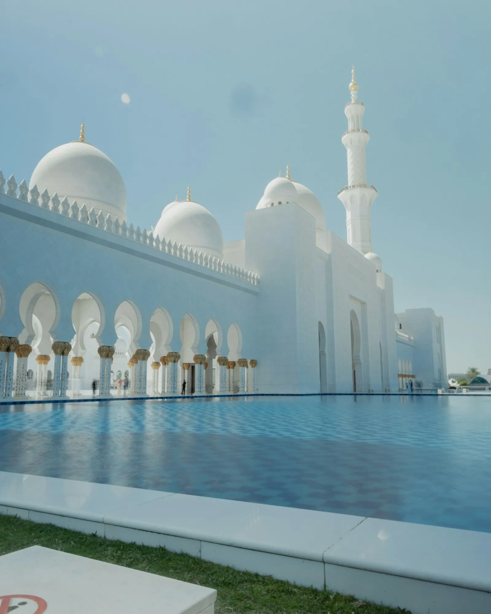 White domes and a reflecting pool at Sheikh Zayed Mosque in Abu Dhabi