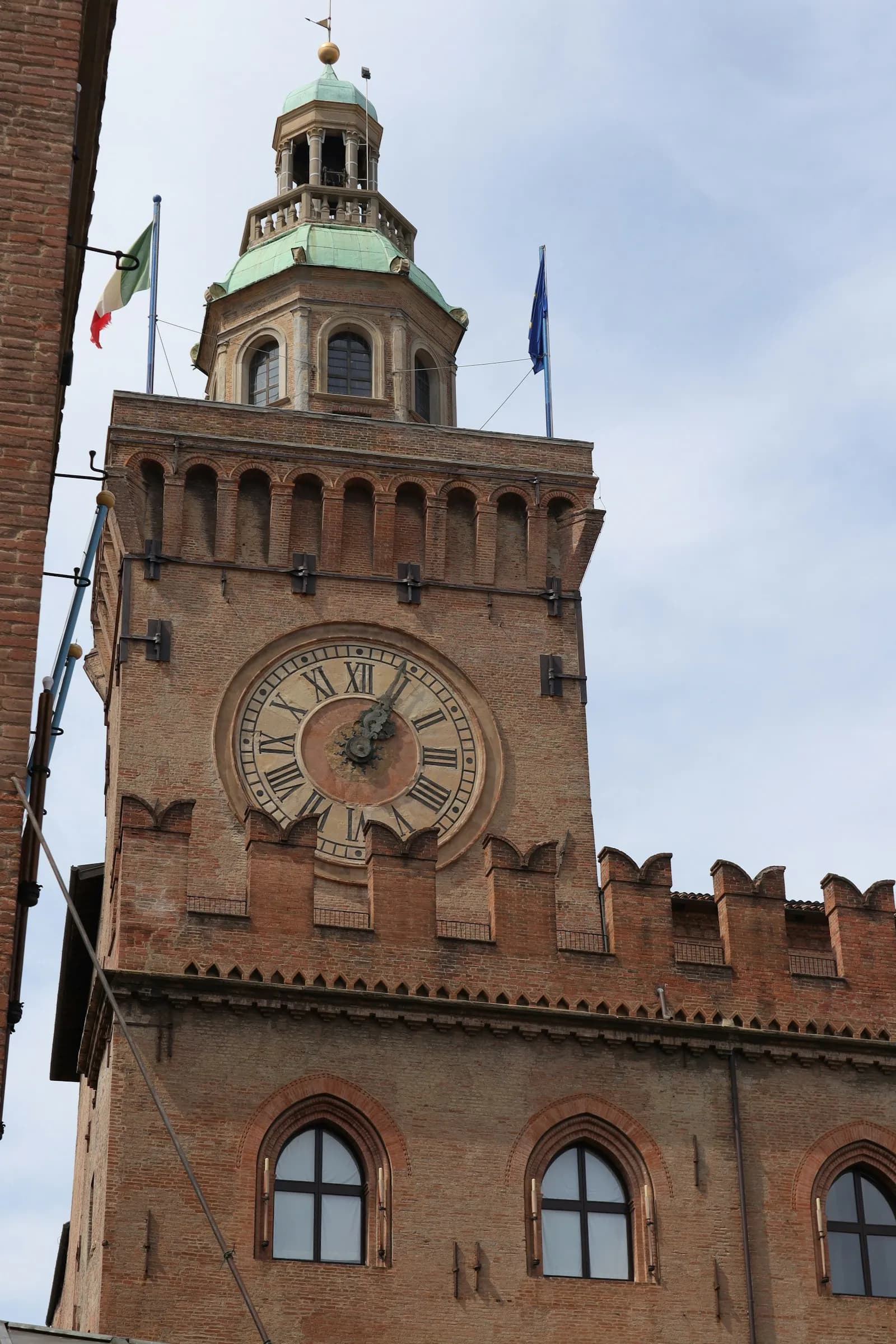 The clock tower of Palazzo d'Accursio above Bologna