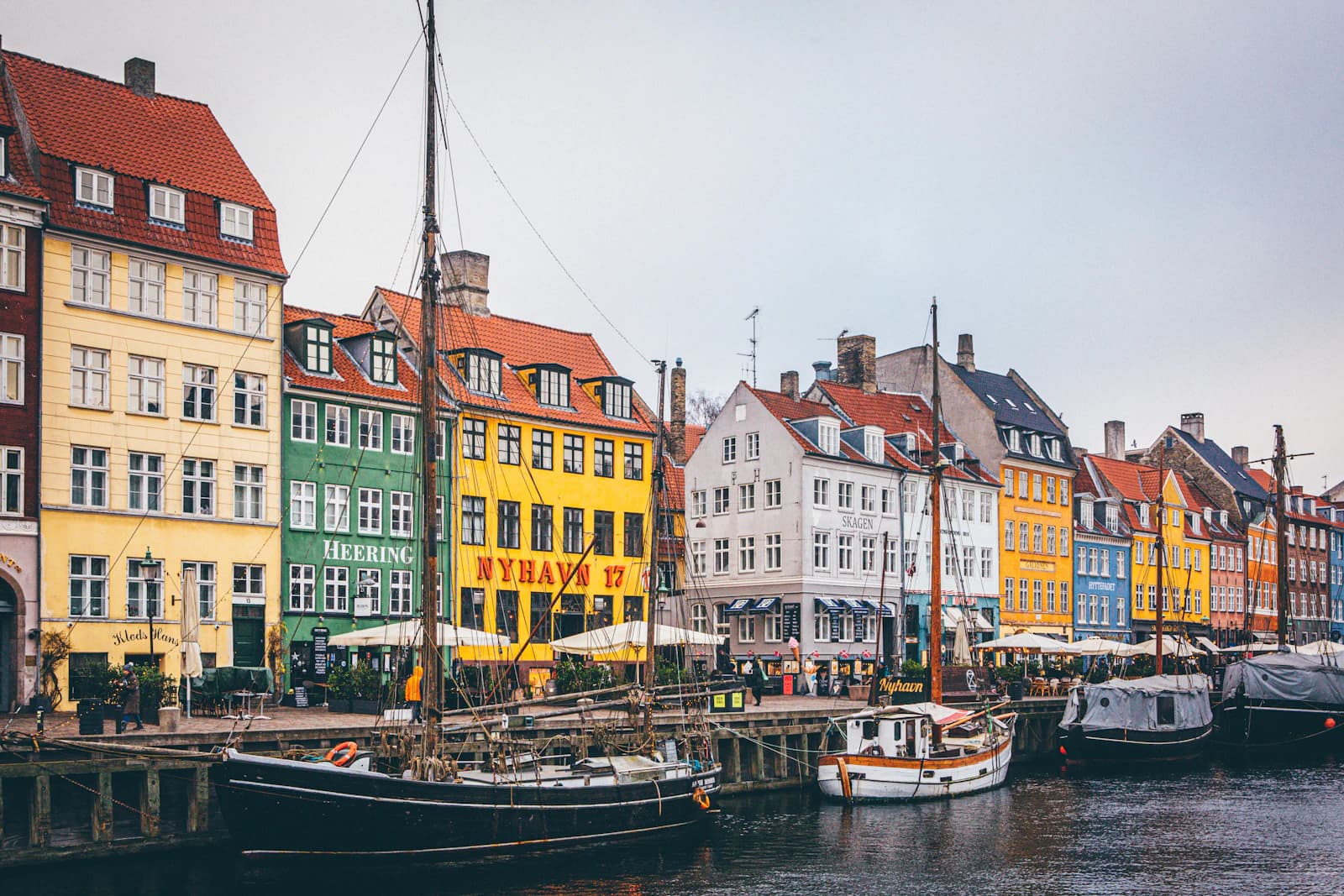Colourful gabled houses and boats along Nyhavn in Copenhagen