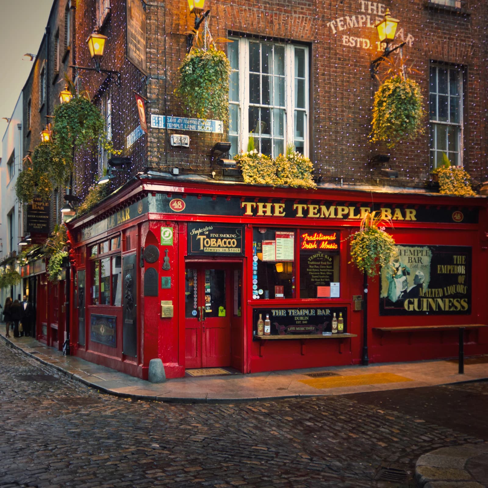 The Temple Bar pub on a cobbled corner in Dublin at dusk