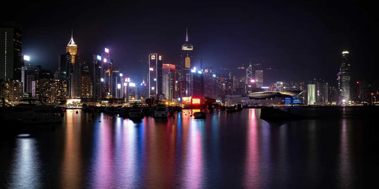 Hong Kong skyline reflected across Victoria Harbour at night