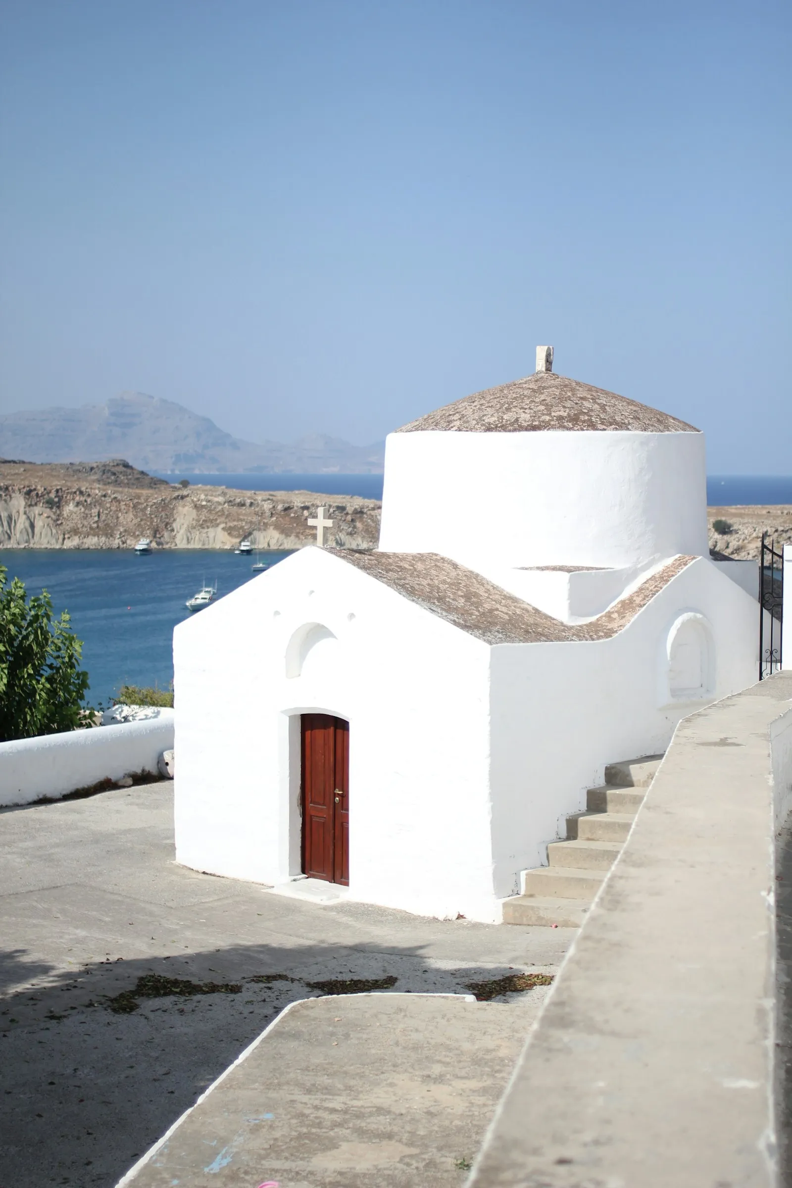 Whitewashed houses and a church above the water in Lindos, Rhodes