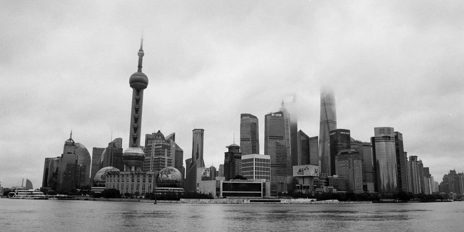 Shanghai skyline and river under a dramatic sky