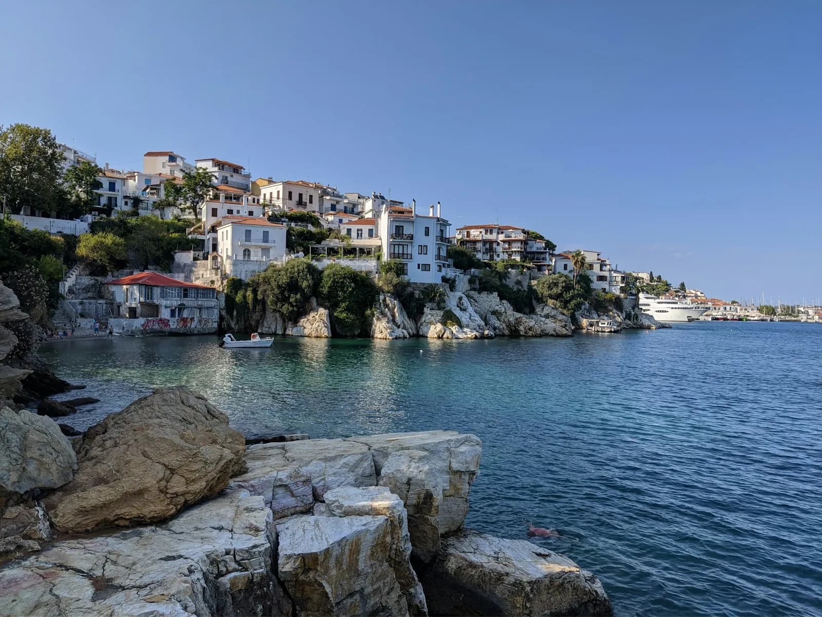 White and ochre houses beside the harbour on Skiathos