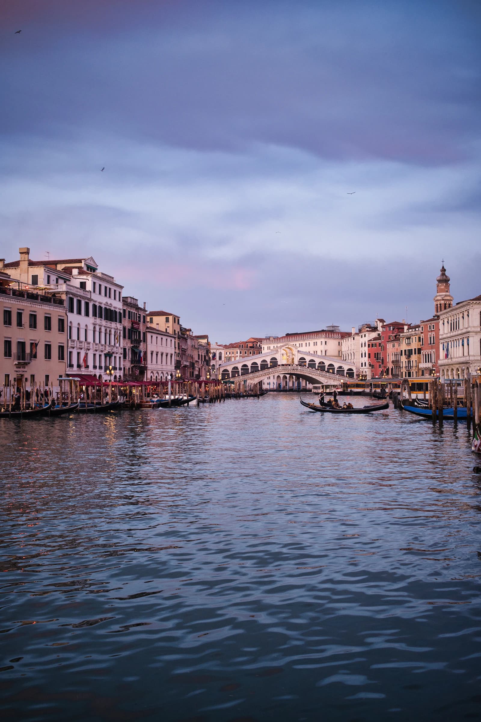 Gondolas on the Grand Canal approaching the Rialto Bridge in Venice