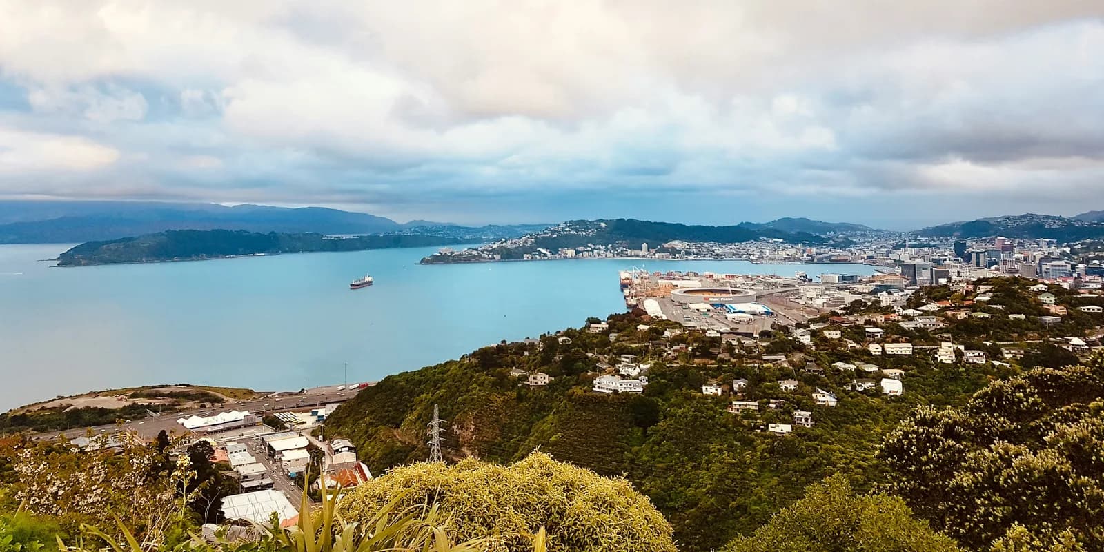 Wellington harbour and hills under a cloudy sky